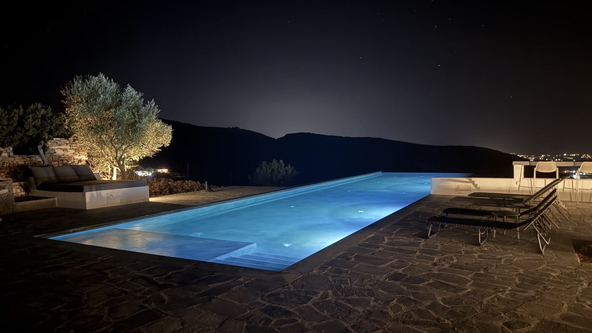 The infinity pool at night under a clear starry sky